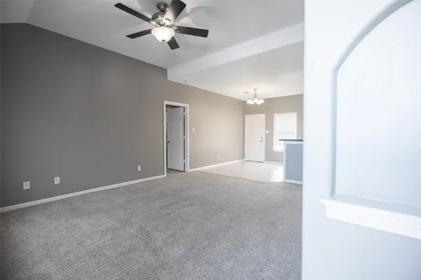a view of a livingroom with a ceiling fan and window