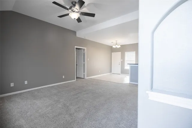 a view of a livingroom with a ceiling fan and window