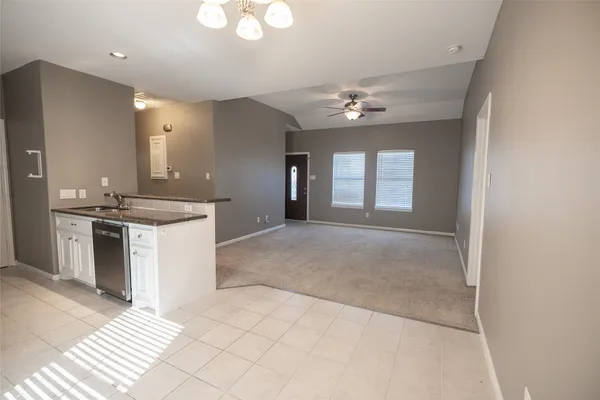 a view of a kitchen with a sink and a chandelier