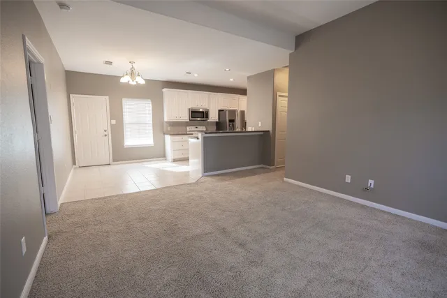 a view of a kitchen and a refrigerator a kitchen island