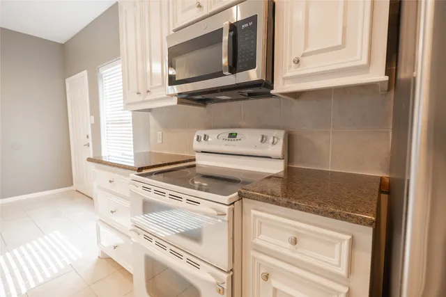 a kitchen with a stove microwave and cabinets
