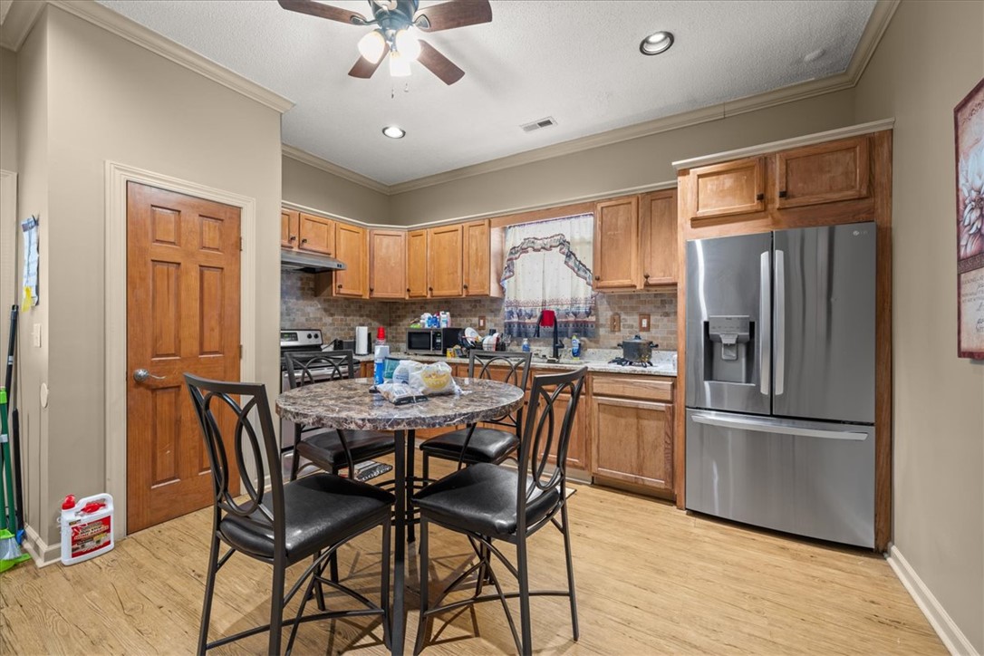 1102 West End Avenue Anderson, SC 29625 - Photo 8 of 28 An inviting kitchen with warm wooden cabinetry and modern stainless steel appliances awaits.