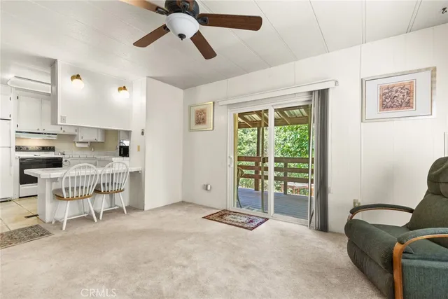 a view of a livingroom with furniture and a window