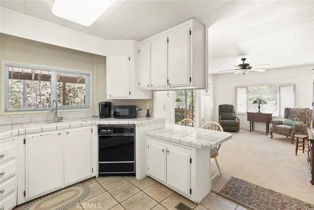 a kitchen with cabinets appliances and a window