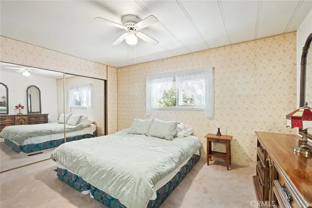 a bedroom with double bed and a chandelier