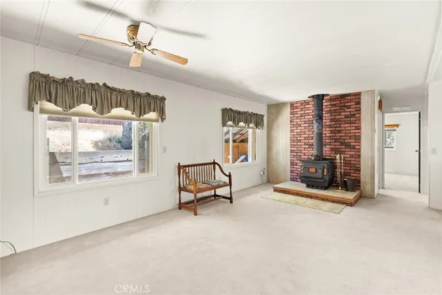 a view of an empty room with a fireplace and a window