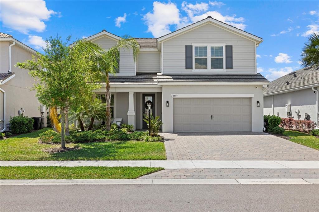 3508 Anchor Bay Trail Lakewood Ranch, FL 34211 - Photo 46 of 74 a front view of a house with a yard and garage