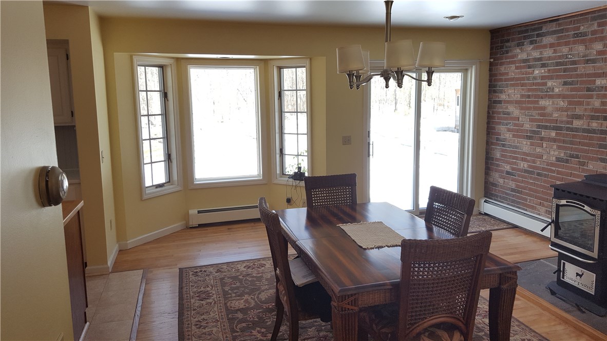 1261 Shannock Road Charlestown, RI 02813 - Photo 8 of 27 view from hallway to dining room and deck to fenced back yard