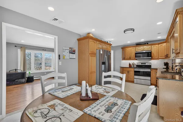 a kitchen with stainless steel appliances granite countertop a stove refrigerator and cabinets