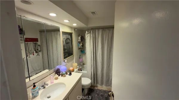 a bathroom with a sink mirror and toilet