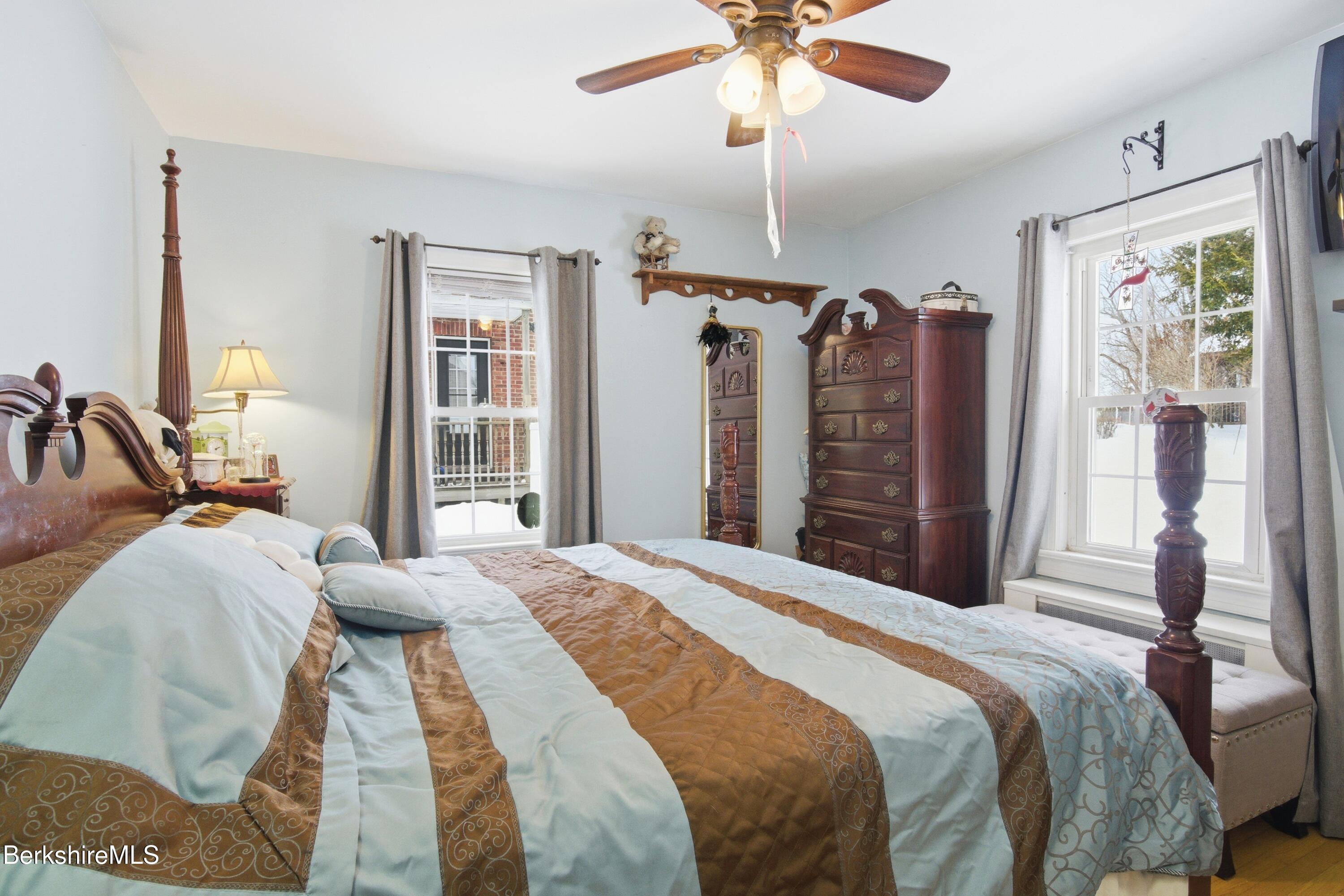 53 Edison Avenue Pittsfield, MA 01201 - Photo 9 of 45 a bedroom with a large bed and a chandelier