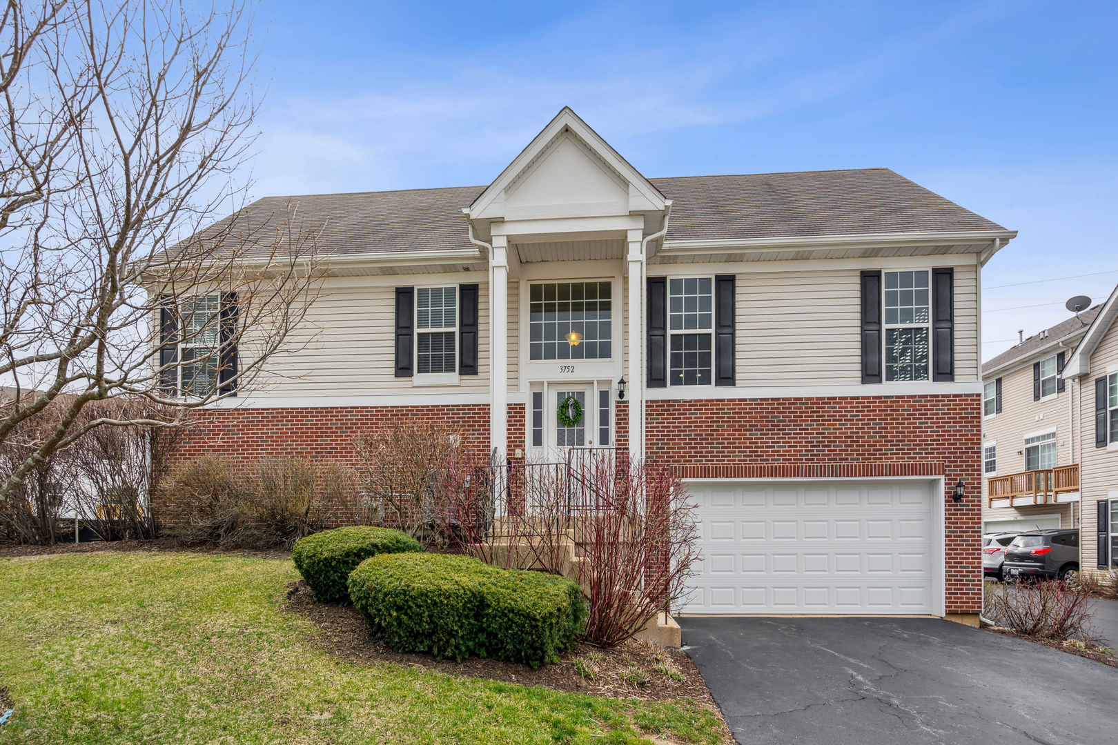 3752 Bailey Road, Unit 3752 Yorkville, IL 60560 - Photo 1 of 20 a front view of a house with a garden and garage