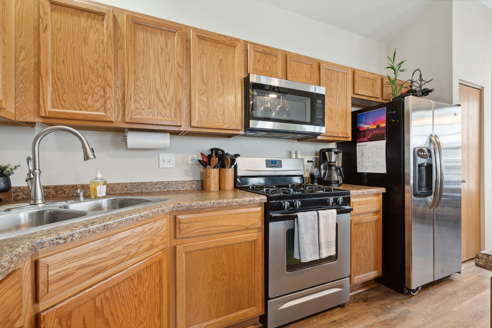 3752 Bailey Road, Unit 3752 Yorkville, IL 60560 - Photo 6 of 20 a kitchen with stainless steel appliances granite countertop a stove a sink and a microwave