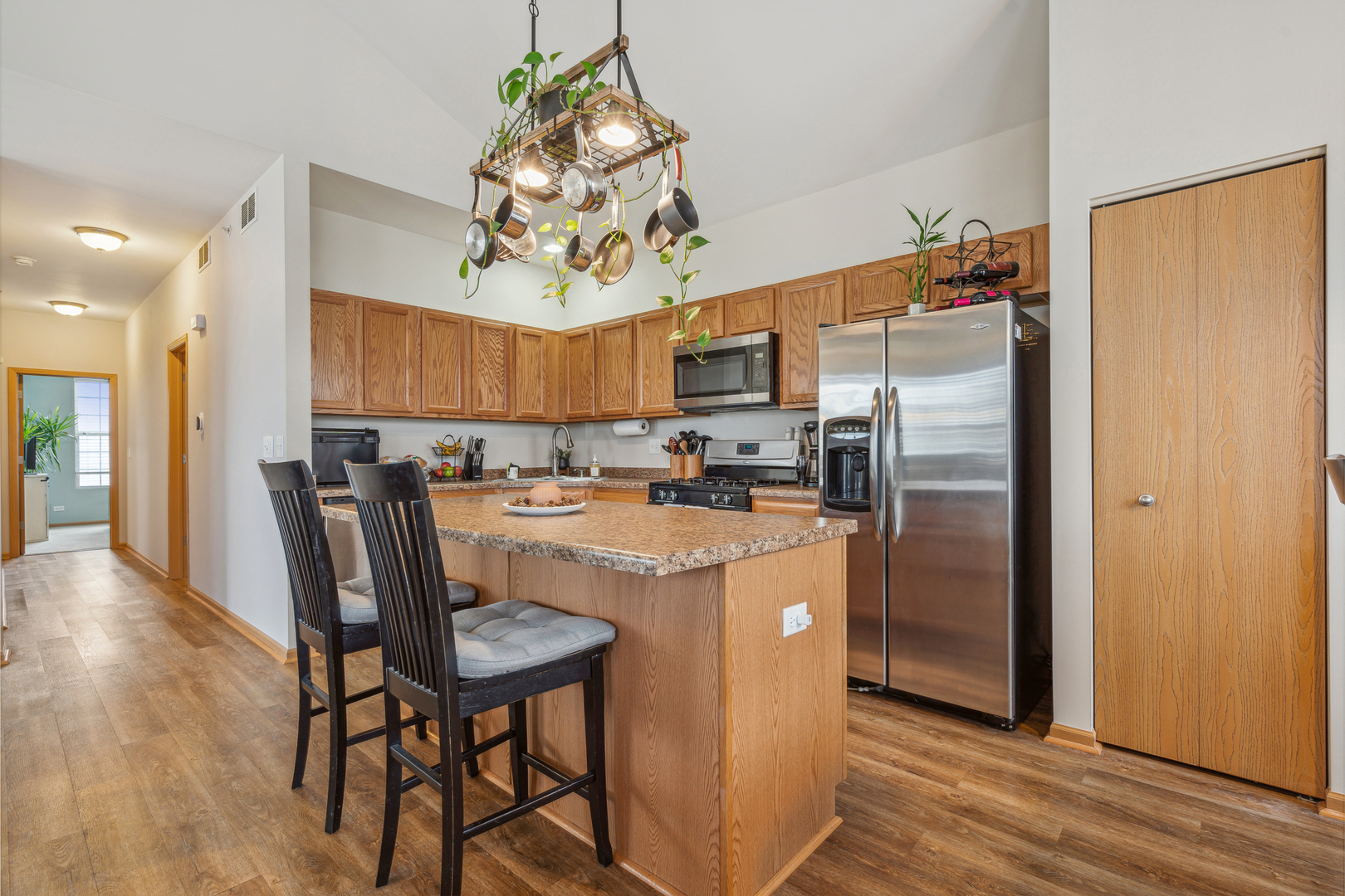 3752 Bailey Road, Unit 3752 Yorkville, IL 60560 - Photo 7 of 20 a kitchen with stainless steel appliances granite countertop a refrigerator a stove a sink dishwasher and a dining table with wooden floor