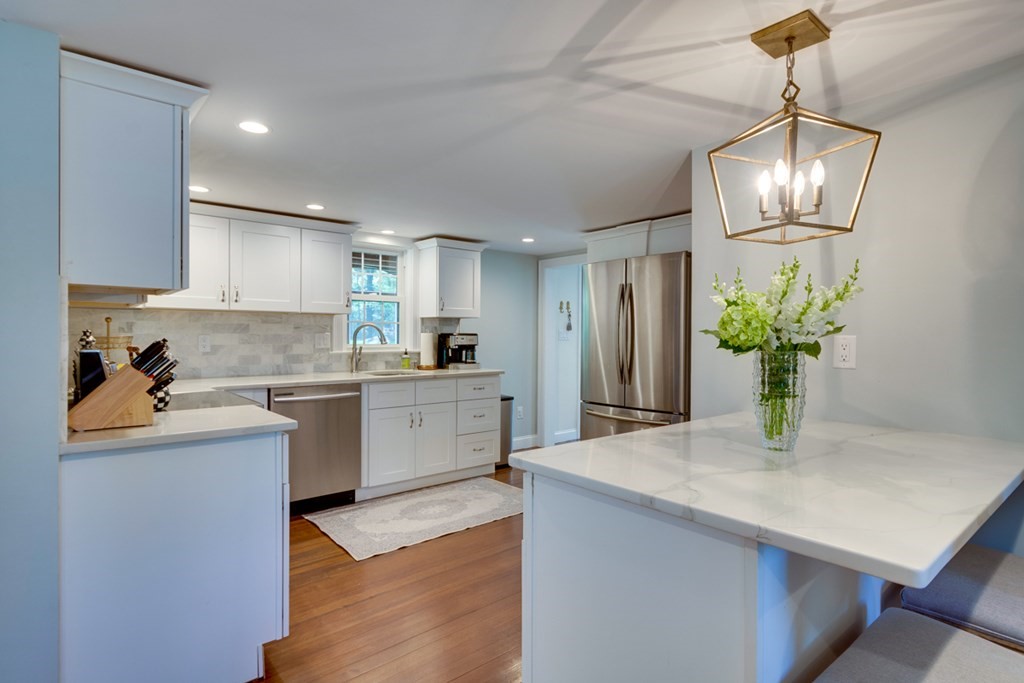 240 Summer Street Walpole, MA 02071 - Photo 11 of 34 a kitchen with a refrigerator and wooden floor