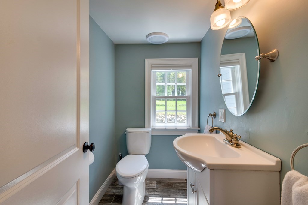 240 Summer Street Walpole, MA 02071 - Photo 15 of 34 a bathroom with a sink toilet a mirror and tub