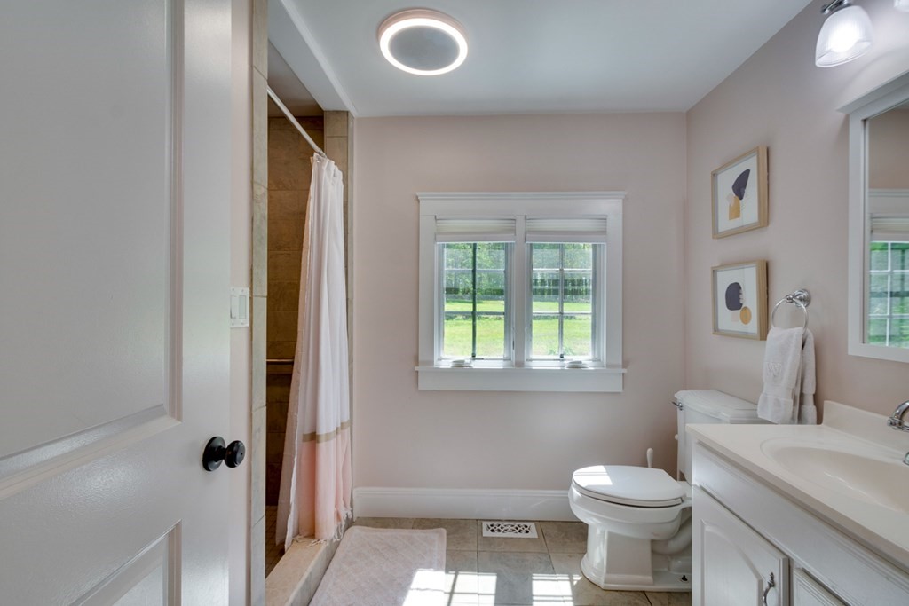 240 Summer Street Walpole, MA 02071 - Photo 21 of 34 a bathroom with a toilet sink a window and shower