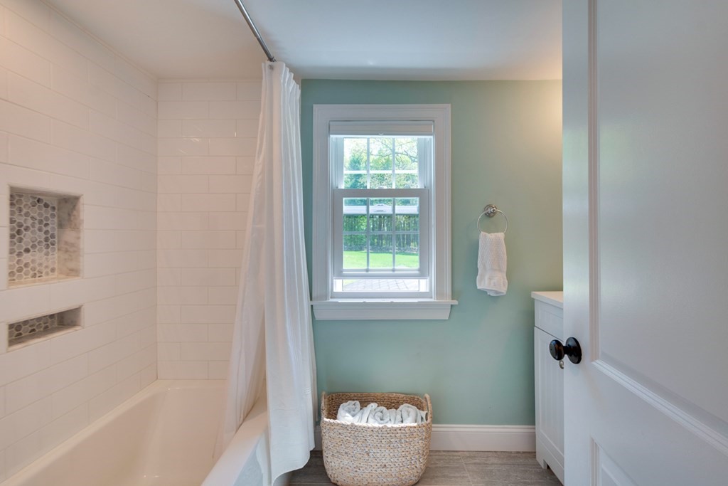 240 Summer Street Walpole, MA 02071 - Photo 24 of 34 a bathroom with a bathtub and window