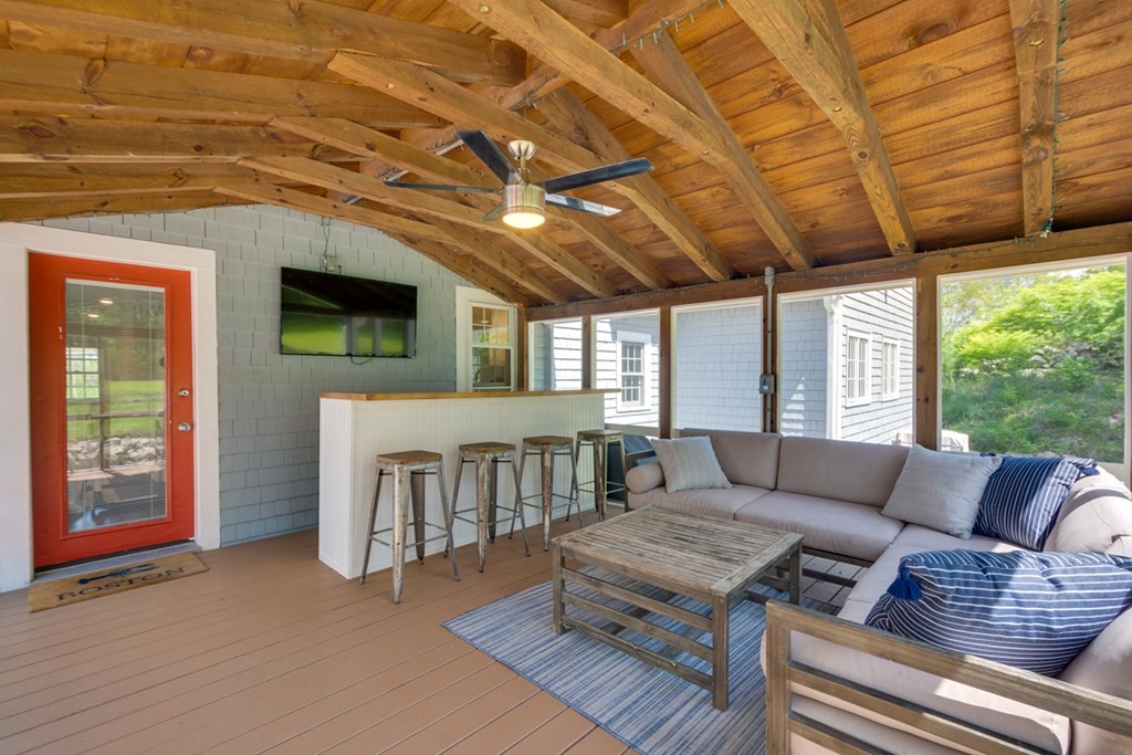 240 Summer Street Walpole, MA 02071 - Photo 29 of 34 a living room with furniture a flat screen tv and a floor to ceiling window