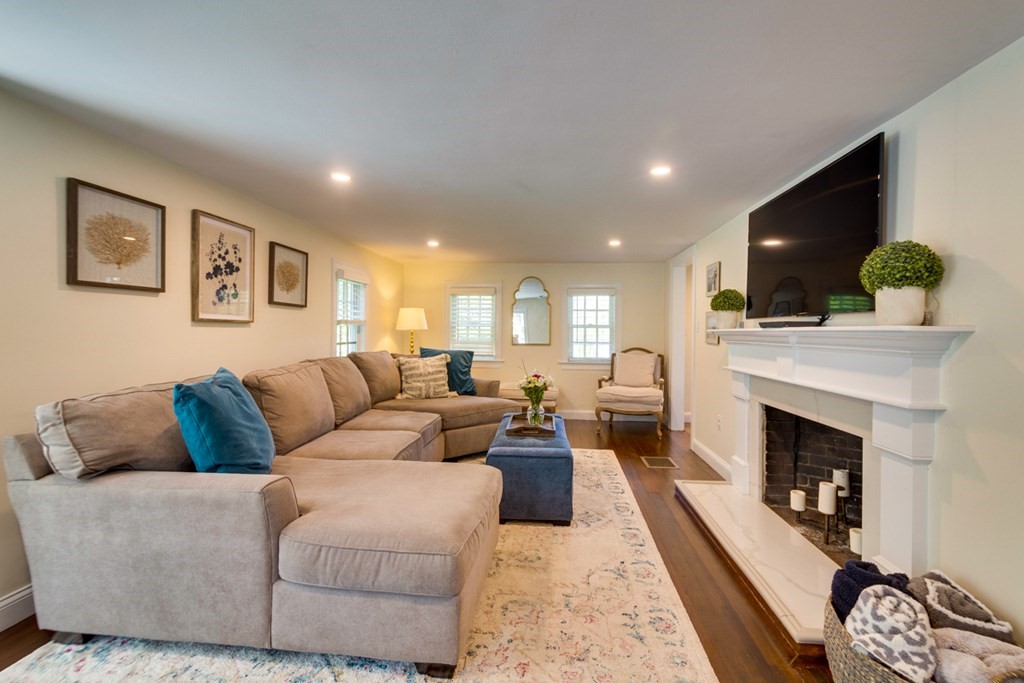 240 Summer Street Walpole, MA 02071 - Photo 4 of 34 a living room with furniture a flat screen tv and a fireplace