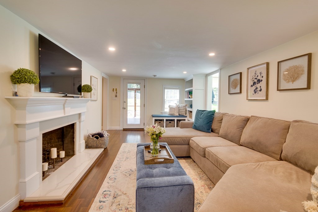 240 Summer Street Walpole, MA 02071 - Photo 6 of 34 a living room with furniture a flat screen tv and a fireplace