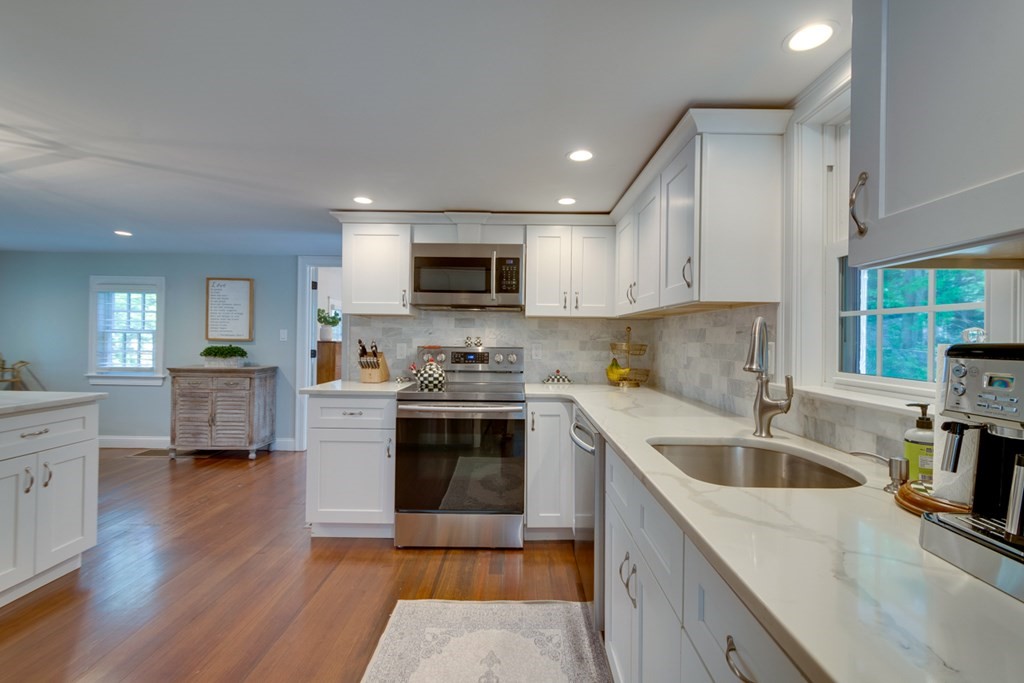 240 Summer Street Walpole, MA 02071 - Photo 9 of 34 a kitchen with a sink stove top oven and refrigerator