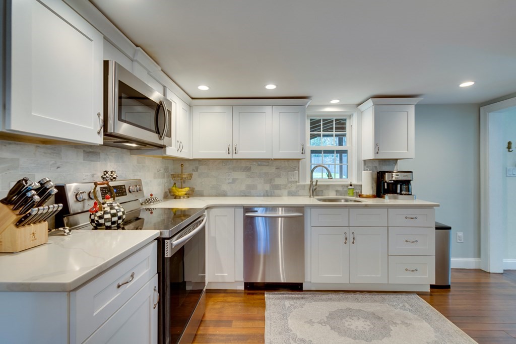 240 Summer Street Walpole, MA 02071 - Photo 10 of 34 a kitchen with stainless steel appliances granite countertop a sink stove and microwave
