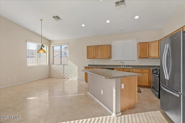 a kitchen with stainless steel appliances granite countertop a stove top oven a sink a granite counter tops and a white cabinets