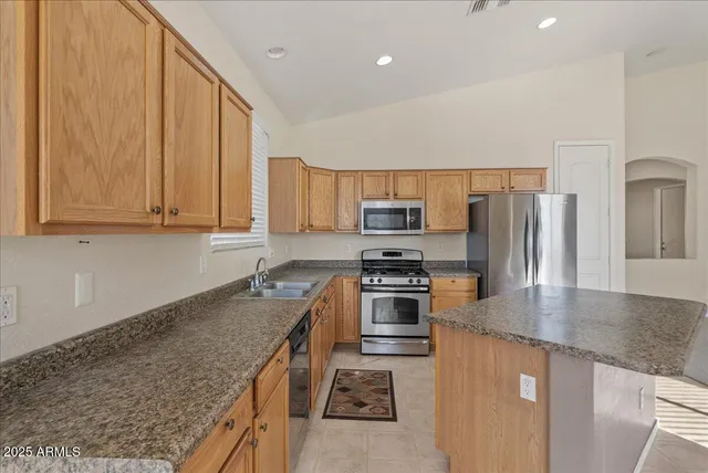 a kitchen with granite countertop a sink and cabinets