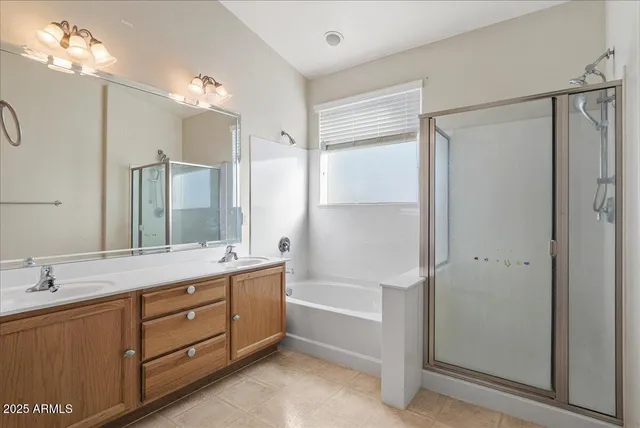 a bathroom with a tub sink and mirror