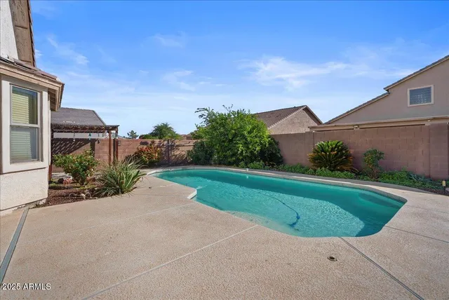 a view of a backyard with plants and a patio