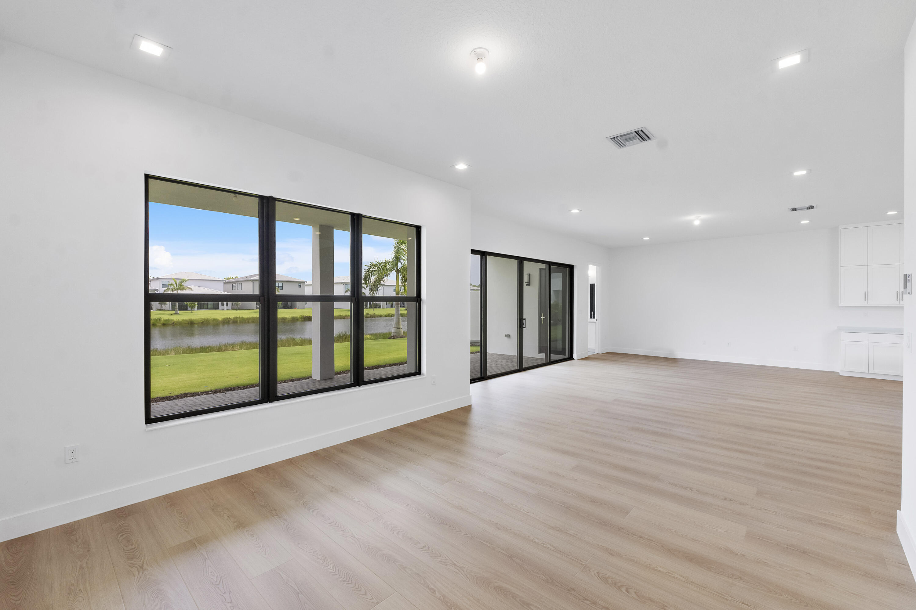 9322 Sunflower Mdw Road Boca Raton, FL 33434 - Photo 26 of 87 a view of an empty room with a window and wooden floor