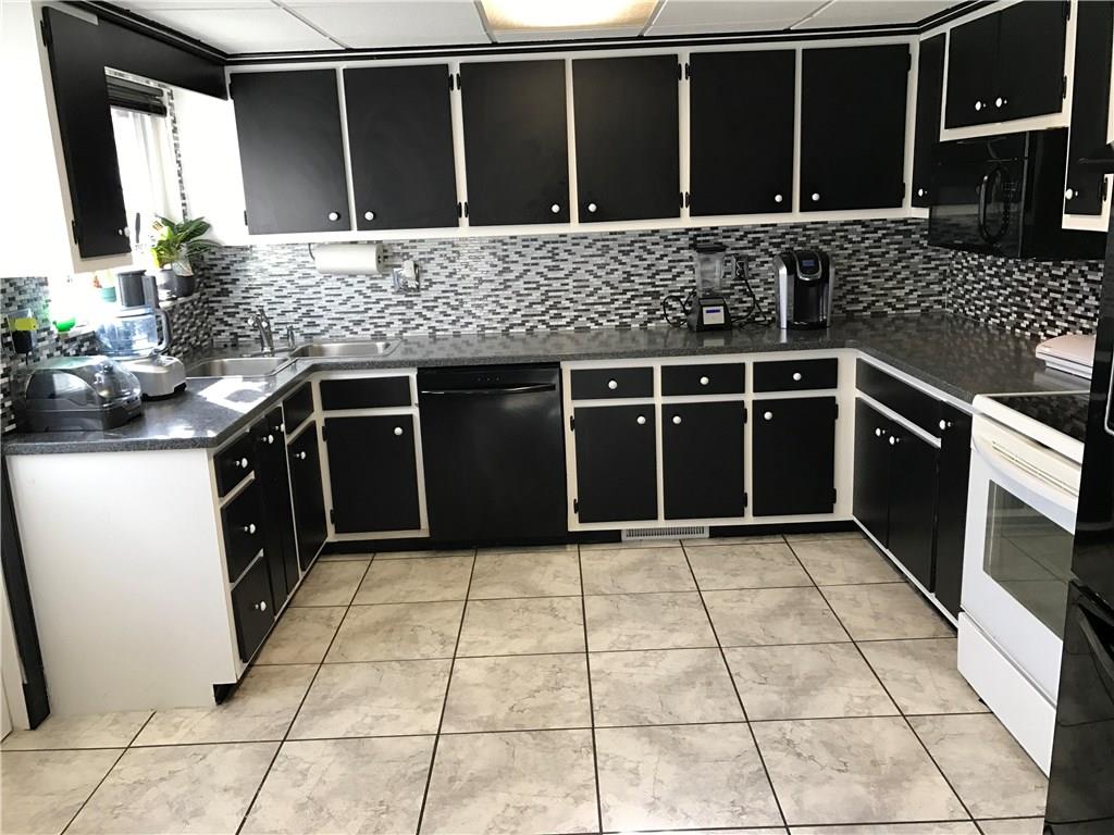 613 Winterberry Road Monroeville, PA 15146 - Photo 6 of 25 This kitchen really pops with the black and white style! Lots of counter-top space and cabinet storage for all your culinary needs.