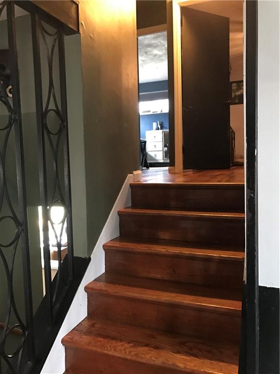 613 Winterberry Road Monroeville, PA 15146 - Photo 10 of 25 The stairway from the kitchen to the bedroom area features beautiful wrought iron on either side of refinished wooden stairs.