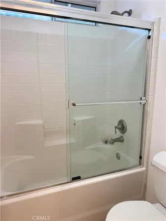 a bathroom with a shower and a toilet