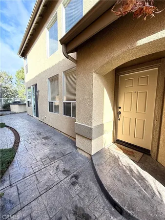 a view of a house with backyard and wooden fence