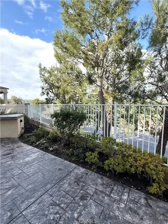 a view of a pathway with a garden
