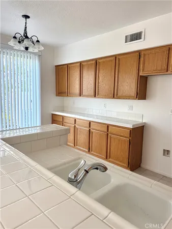 a kitchen with a cabinets and chandelier