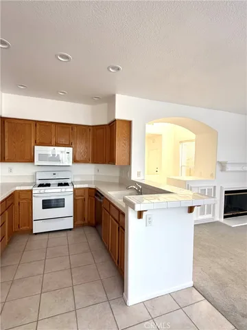 a kitchen with stainless steel appliances a stove sink and cabinets