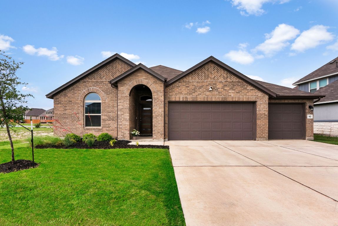 a front view of house with yard and green space