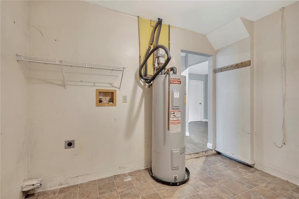 7737 Mitchell Ranch Road New Port Richey, FL 34655 - Photo 13 of 27 a view of water heater room with hallway