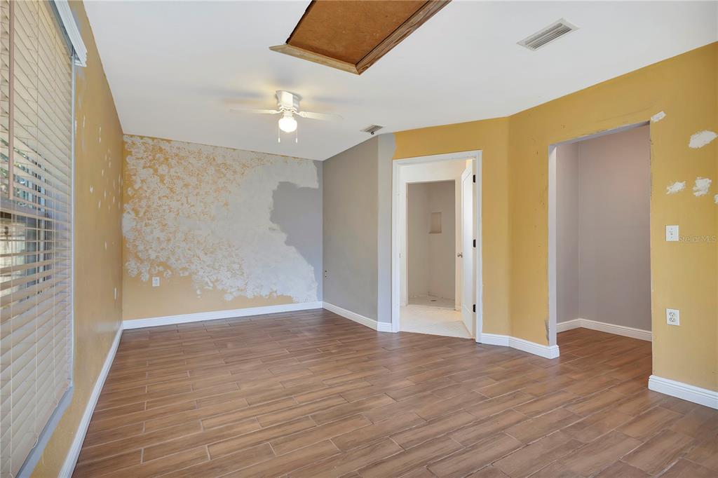 7737 Mitchell Ranch Road New Port Richey, FL 34655 - Photo 15 of 27 a view of an empty room with wooden floor and a window