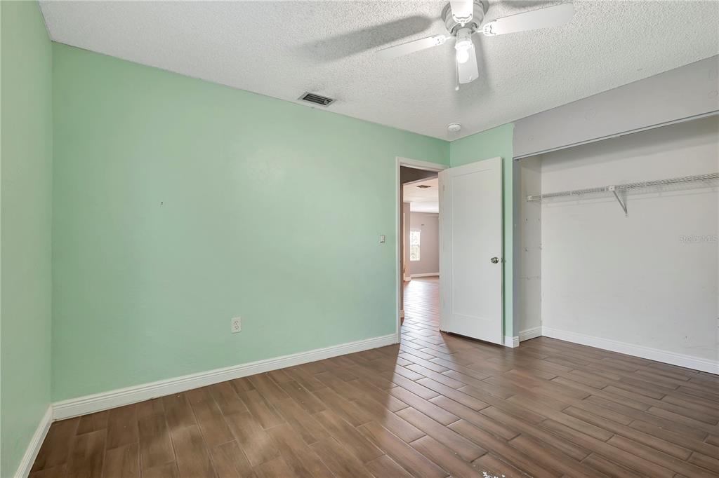 7737 Mitchell Ranch Road New Port Richey, FL 34655 - Photo 20 of 27 a view of an empty room with wooden floor