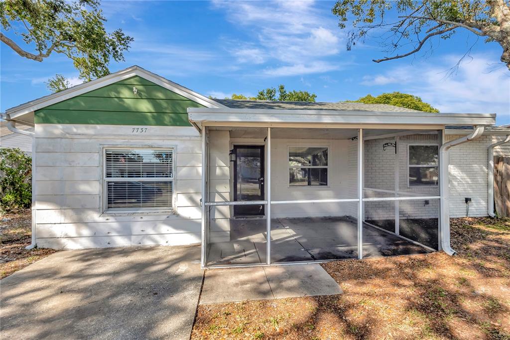 7737 Mitchell Ranch Road New Port Richey, FL 34655 - Photo 2 of 27 a front view of a house with a yard