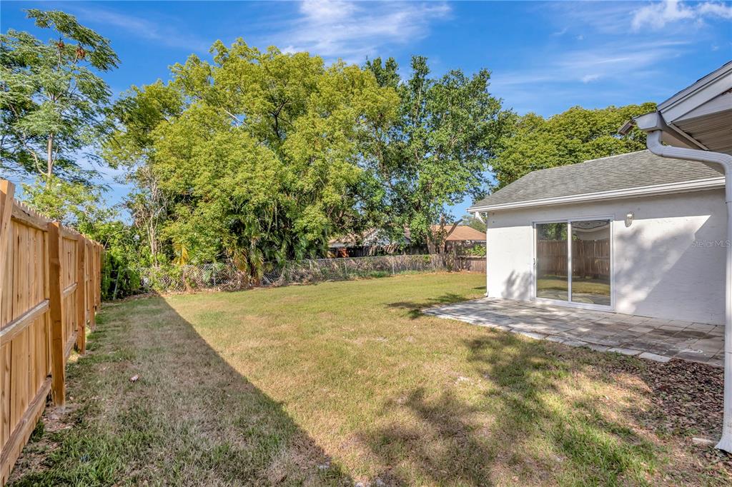7737 Mitchell Ranch Road New Port Richey, FL 34655 - Photo 23 of 27 a view of a house with backyard and sitting area