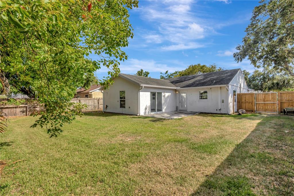 7737 Mitchell Ranch Road New Port Richey, FL 34655 - Photo 24 of 27 a view of a house with a backyard