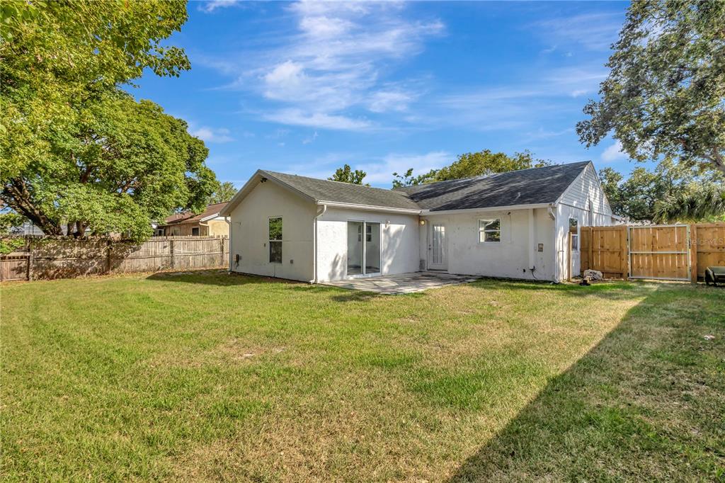 7737 Mitchell Ranch Road New Port Richey, FL 34655 - Photo 25 of 27 a view of a house with a backyard