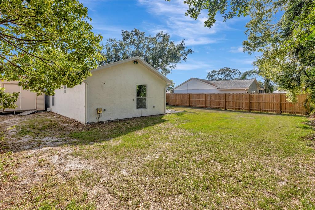 7737 Mitchell Ranch Road New Port Richey, FL 34655 - Photo 26 of 27 a view of a house with a yard
