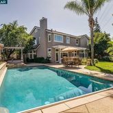 a view of a house with swimming pool and sitting area