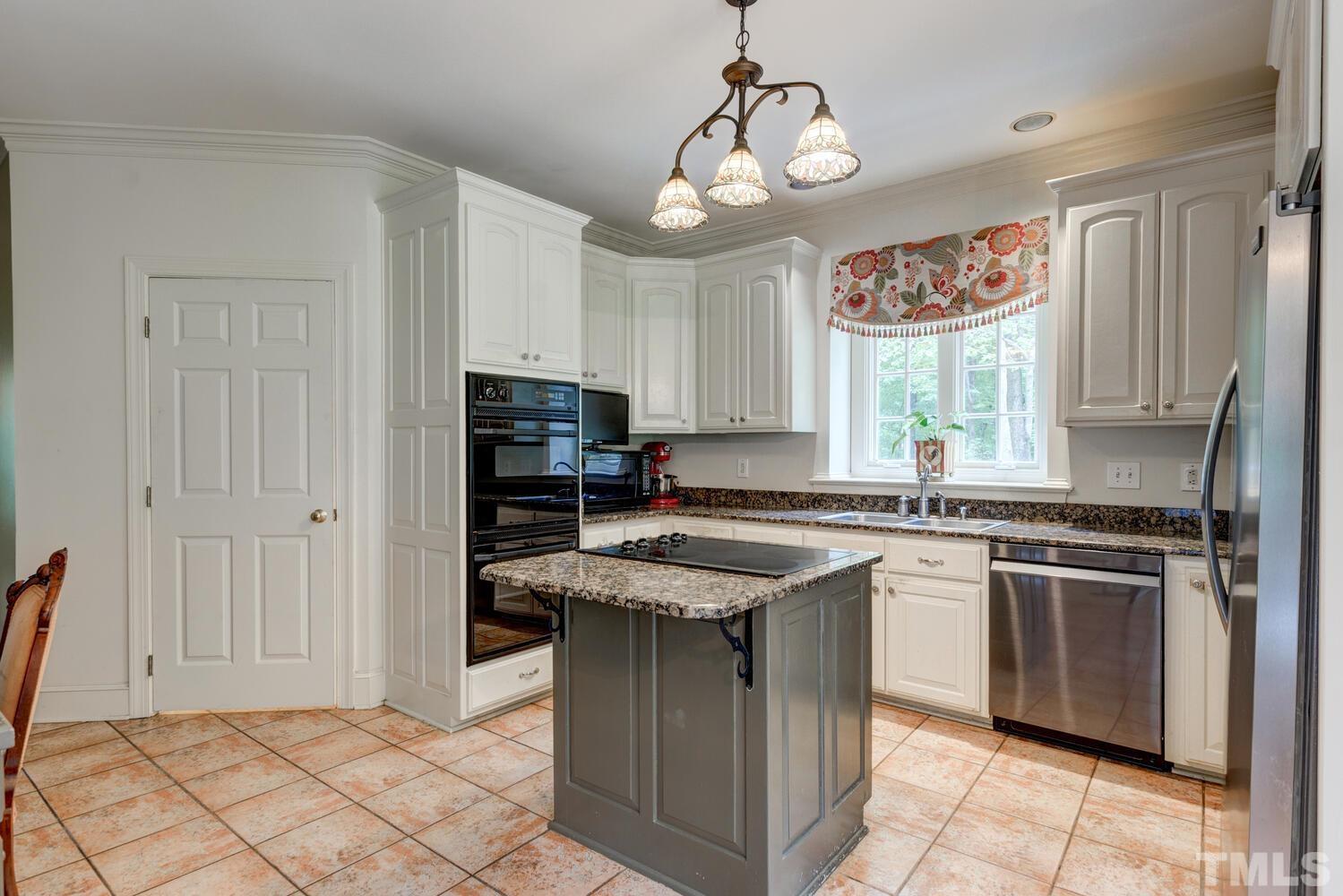 2021 Rolling Rock Road Wake Forest, NC 27587 - Photo 13 of 27 a kitchen with stainless steel appliances granite countertop a stove top oven a sink dishwasher and a refrigerator